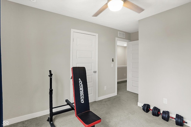 exercise room with ceiling fan and carpet