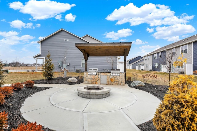 view of patio / terrace with an outdoor kitchen, a grill, and a fire pit