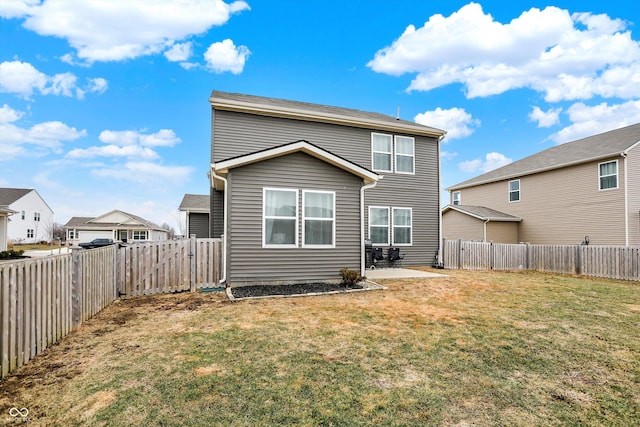 back of house featuring a yard and a patio area