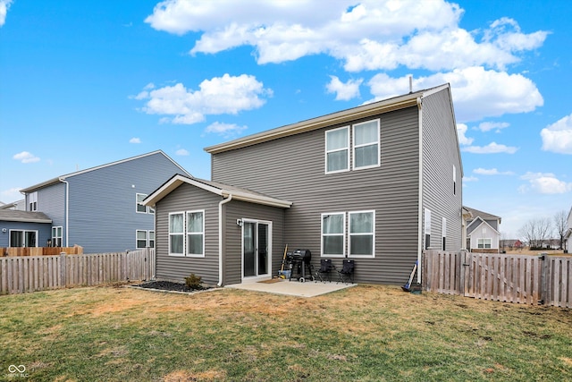 back of house with a patio and a lawn