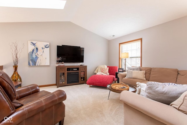 living room with lofted ceiling with skylight and light carpet