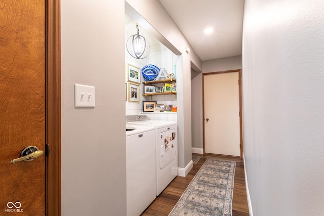 laundry area featuring dark wood-type flooring and washer and clothes dryer