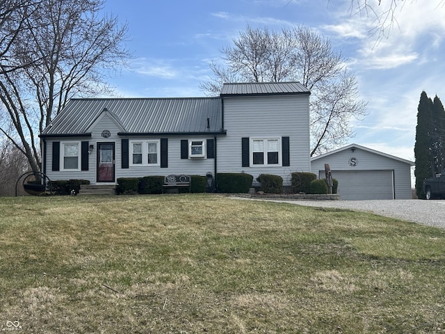 view of front of house featuring an outbuilding, a garage, metal roof, and a front yard