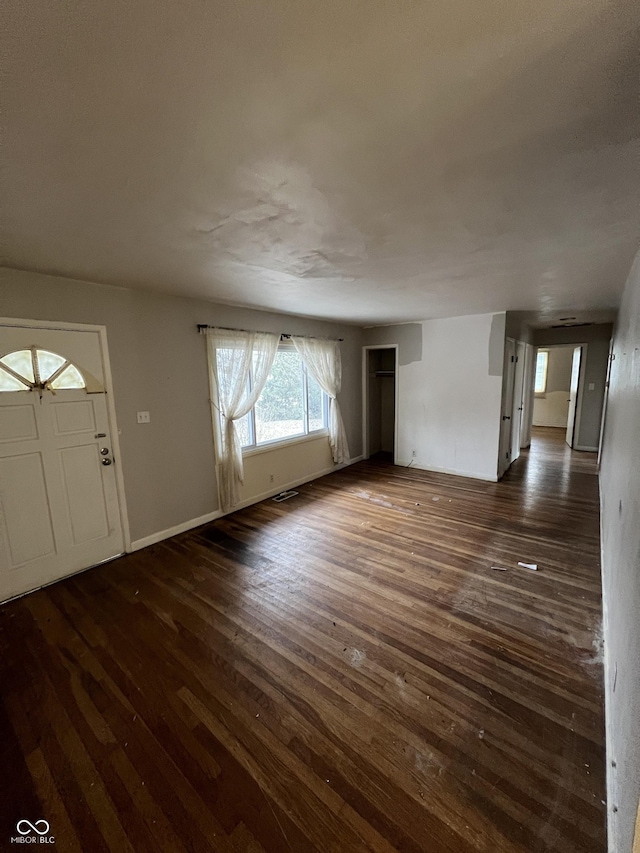 foyer entrance with dark hardwood / wood-style floors