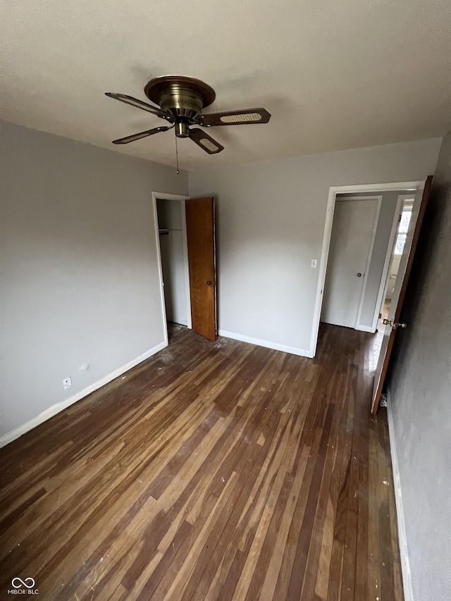 interior space with ceiling fan and dark hardwood / wood-style floors