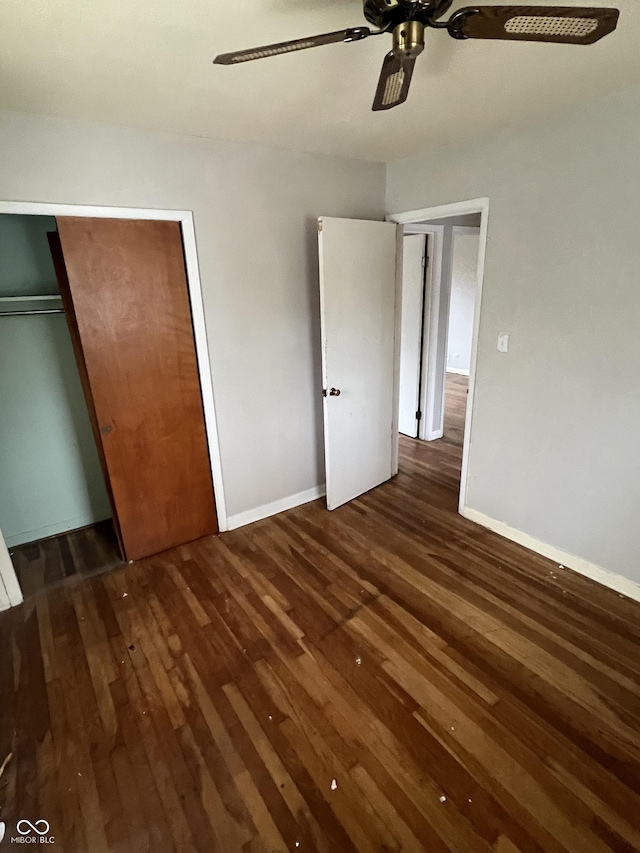 unfurnished bedroom featuring dark hardwood / wood-style flooring and ceiling fan