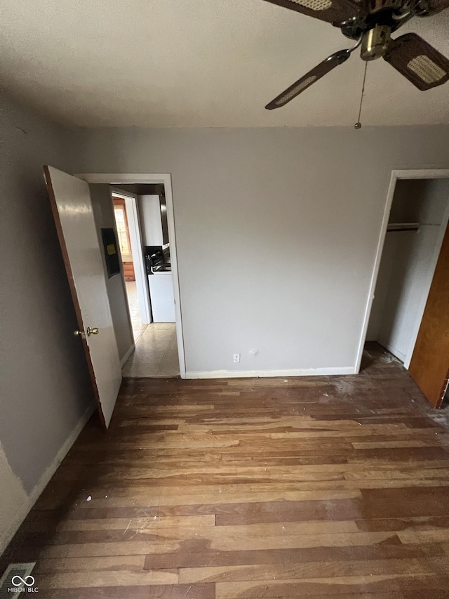 unfurnished bedroom with hardwood / wood-style floors, ceiling fan, and a closet