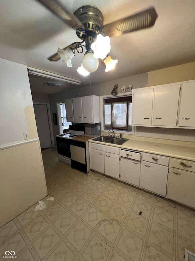 kitchen featuring sink, dishwasher, ceiling fan, white cabinetry, and electric range