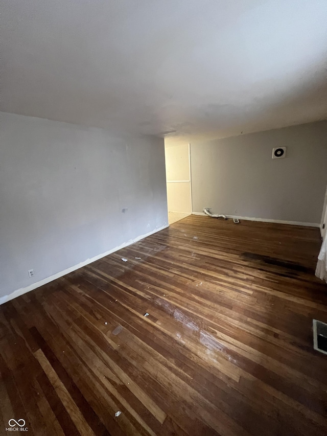 empty room with dark wood-type flooring