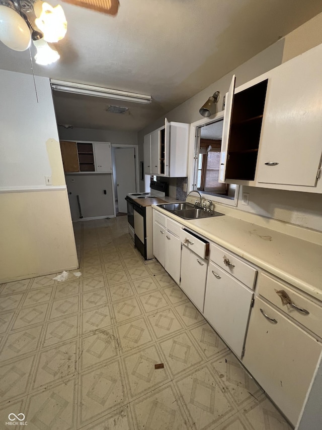 kitchen with white cabinetry, sink, and black / electric stove