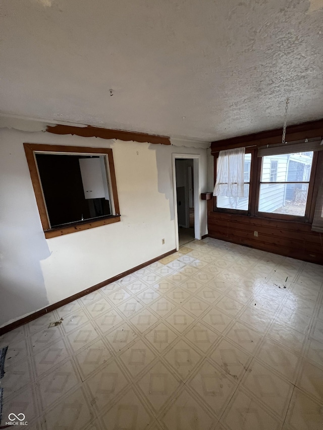 unfurnished room featuring a textured ceiling