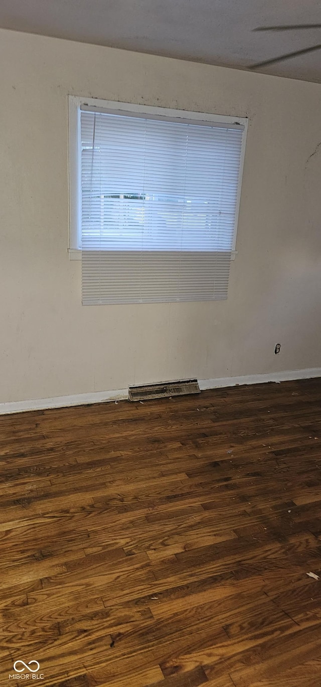 spare room featuring dark hardwood / wood-style flooring