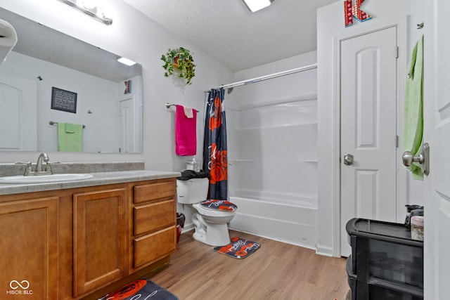 full bathroom featuring vanity, toilet, hardwood / wood-style floors, and shower / bath combo with shower curtain