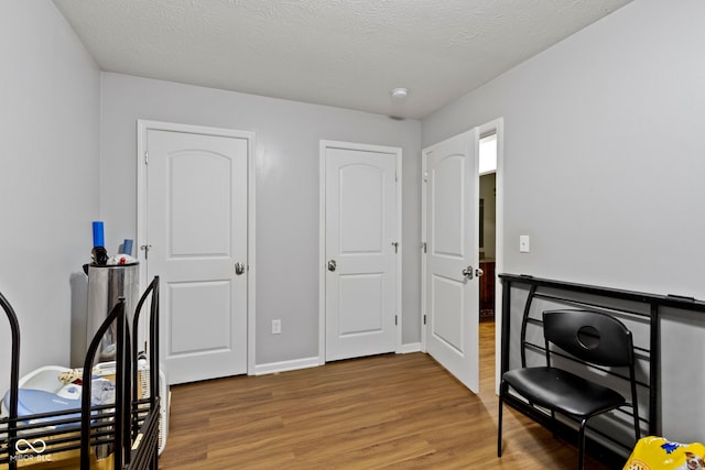 office featuring hardwood / wood-style floors and a textured ceiling