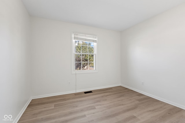 unfurnished room with visible vents, baseboards, and light wood finished floors