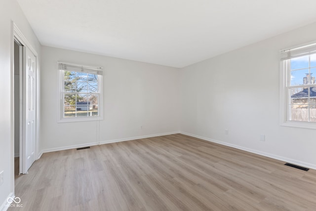 interior space with light wood finished floors, visible vents, a closet, and baseboards