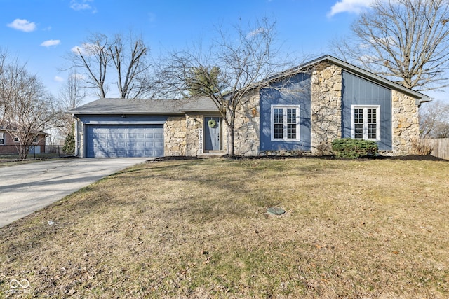 mid-century inspired home featuring driveway, fence, a garage, and stone siding