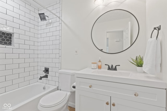 bathroom featuring vanity, shower / tub combination, and toilet