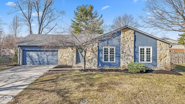 view of front facade with concrete driveway, an attached garage, fence, and stone siding