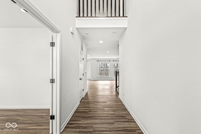 hallway with recessed lighting, baseboards, and wood finished floors