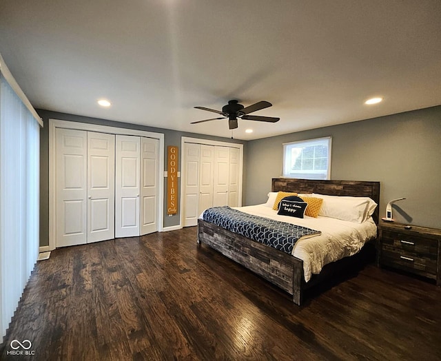 bedroom featuring multiple closets, ceiling fan, and dark wood-type flooring