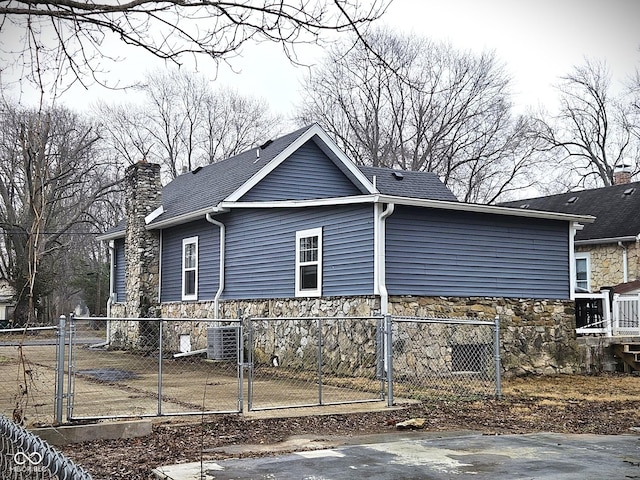 view of side of property featuring central AC