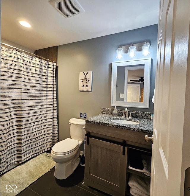 bathroom with tile patterned flooring, vanity, a shower with curtain, and toilet