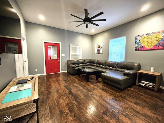 living room featuring dark wood-type flooring and ceiling fan