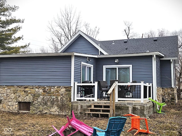 rear view of house featuring a wooden deck