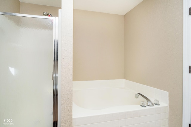 full bathroom featuring a garden tub and a shower stall