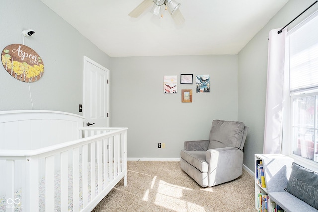 carpeted bedroom with a ceiling fan and baseboards