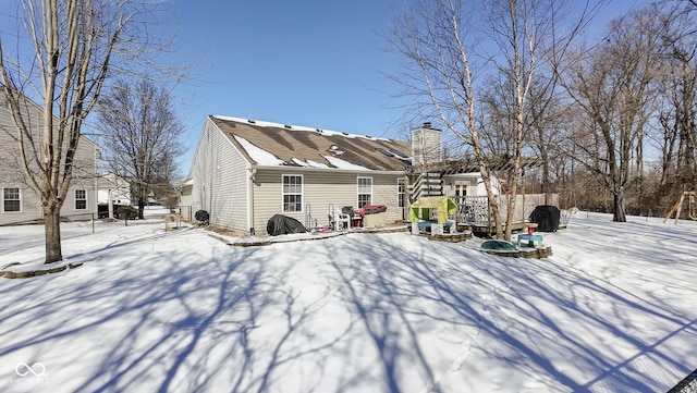 snow covered house with a chimney