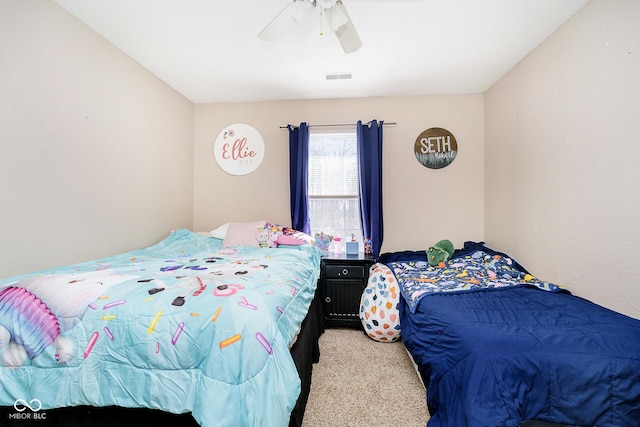 bedroom featuring ceiling fan, visible vents, and light colored carpet