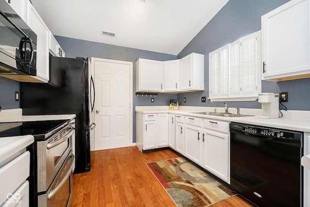 kitchen featuring black appliances, light countertops, visible vents, and white cabinets