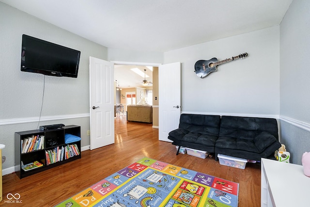 game room featuring ceiling fan, baseboards, and wood finished floors