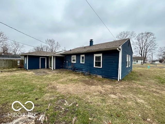 rear view of property with a yard