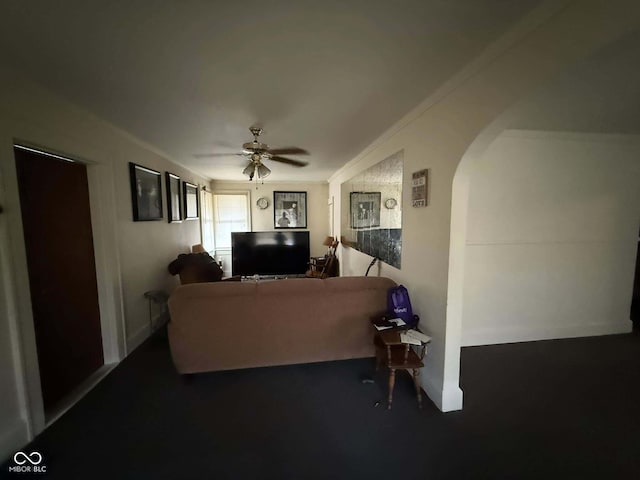 living room with crown molding and ceiling fan