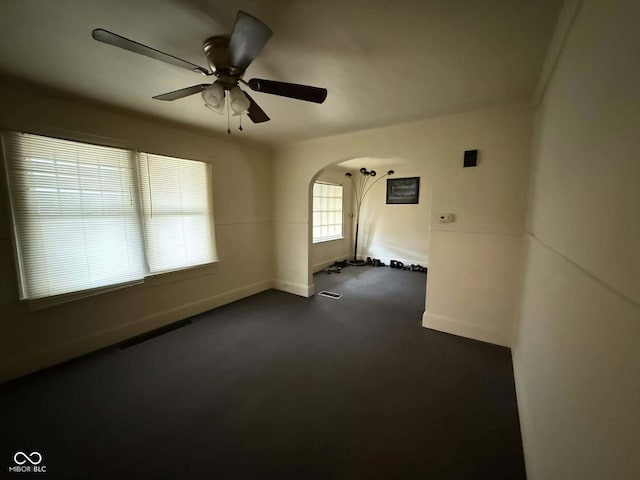 carpeted spare room featuring ceiling fan