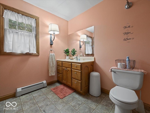 bathroom with vanity, a baseboard radiator, and toilet