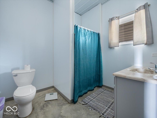 bathroom with vanity, concrete floors, walk in shower, and toilet