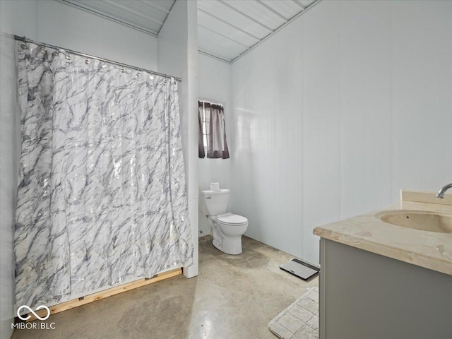 bathroom with vanity, concrete flooring, and toilet