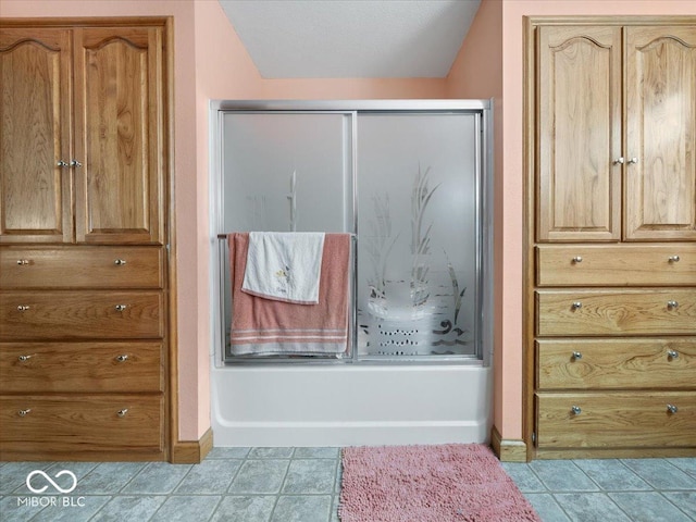 bathroom with lofted ceiling, tile patterned floors, and combined bath / shower with glass door