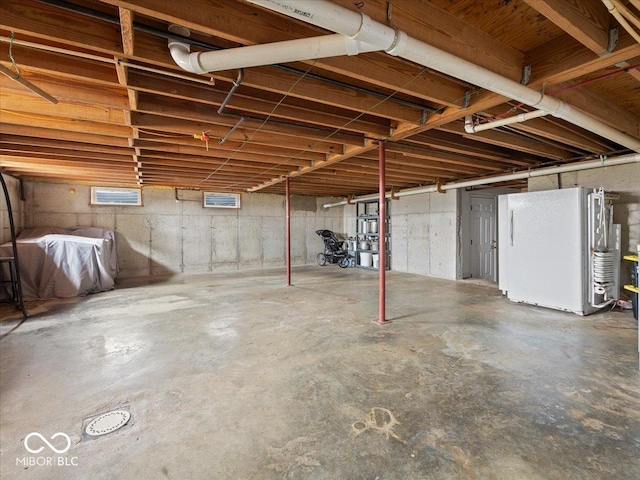 basement with white fridge