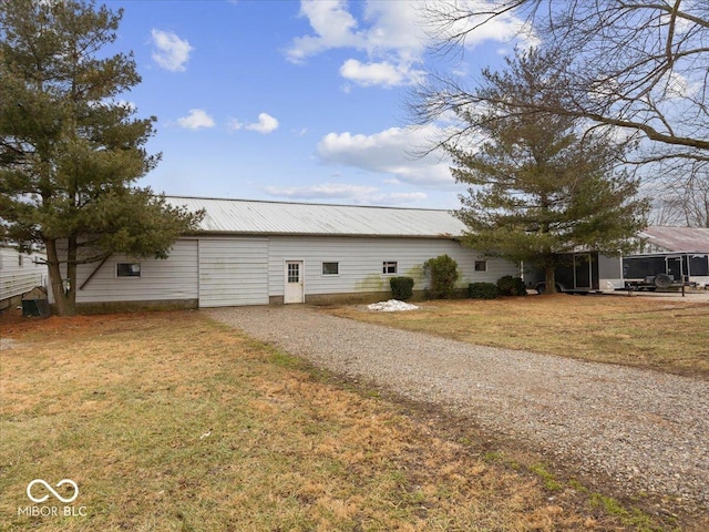 view of side of home with a lawn