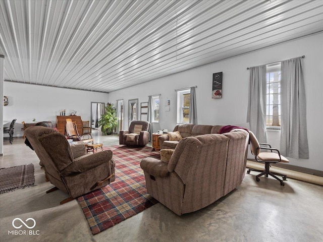 living room featuring a healthy amount of sunlight and concrete floors