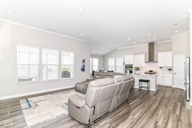 living room featuring ornamental molding, light wood-type flooring, and baseboards