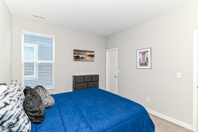 bedroom with carpet, visible vents, and baseboards