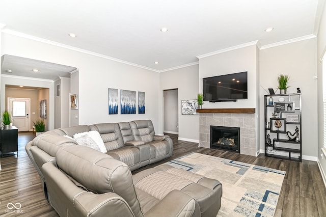 living area featuring crown molding, dark wood-type flooring, a fireplace, and baseboards