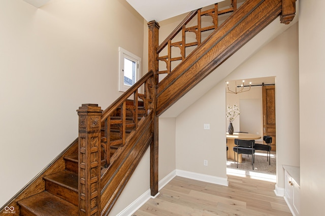 stairway featuring hardwood / wood-style floors and a barn door