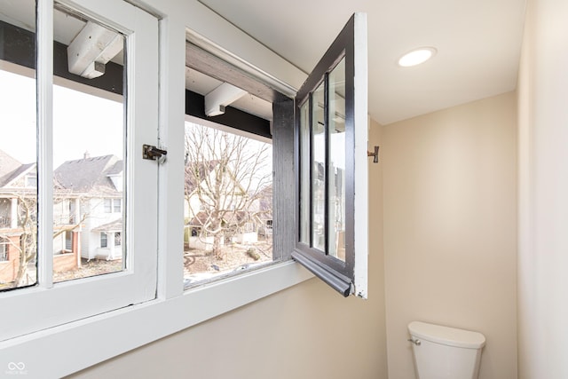 bathroom with toilet and a healthy amount of sunlight